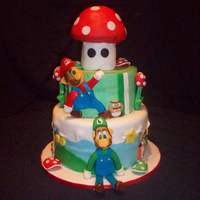 Mario Birthday Figures made from fondant/gumpaste mixture. Mushroom is RK treat covered in fondant.