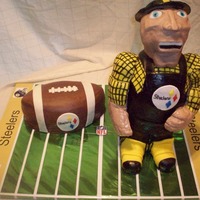 Steely Mcbeam Steelers mascot, Steely McBeam - carved body from cake, head and arms are RK treats covered in fondant. Board is not cake.