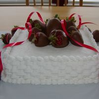 My Husband's Birthday Cake First attempt at basket weave. Buttercream icing on a square cake with chocolate dipped strawberries.