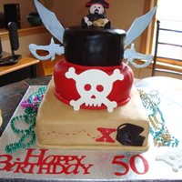 Pirate Cake Made for dh 50th birthday. Bottom layer was mojito flavored cake covered in fondant. Fondant pirate figure and mug. Gumpaste decorations.