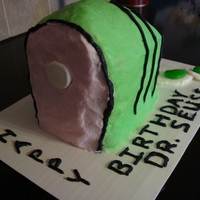 Green Eggs And Ham Vanilla cake tinted green and iced with buttercream. Eggs are gumpaste and fondant. Only my second carved cake made for a class of first...