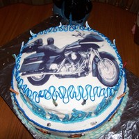 Harley Cake Birthday cake for a good friend. The Harley is a sugarlay of his motorcycle. Buttercream frosting with harley emblems & blue flames...