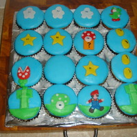 Mario Cupcakes Made these for my son's 11th Birthday. Cupcakes are white chocolate. Copied the design. Mario's a little thin and Yoshi is a...