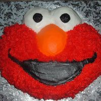 Elmo! Elmo character cake, all iced in buttercream, filled with a little vanilla buttercream and sliced fresh strawberries, french vanilla cake...