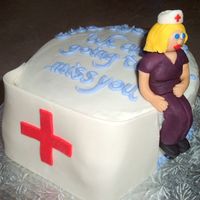 Nurse's Cap Cake Shaped to look like a nurse's cap done in gumpaste/fondant is leaning against a 8" chocolate banana cake filled with vanilla...