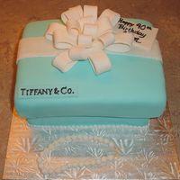 Tiffany Gift Box French vanilla cake filled with chocolate ganache made to look like a Tiffany gift box. Home-made fondant covers the cake along with...