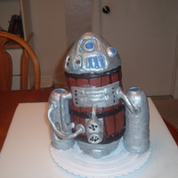 Steampunk R2D2 Eight layers of yellow butter cake with buttercream frosting covered in chocopan fondant.Legs are made with rice krispy treats covered in...
