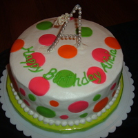 Polkadots And Pearls Buttercream with fondant polkadots. Topper is a Christmas ornament--birthday girl's initial.