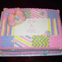 Baby Shower Cake - White Chocolate Booties - Baby Blanket Design The booties are made from white chocolate colored pink with a baby blanket design piped in buttercream.