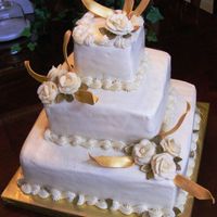 Golden Anniversary Cake This is a 3 tier stacked buttercream cake with a reverse scroll border. It has buttercream roses and fondant leaves/accents painted with...