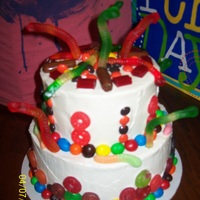 Candy Cake Orange/Chocolate cake with Whipped vanilla icing and loaded with gummy lifesavers/ Gummy worrms m&ms reese's peices and other...