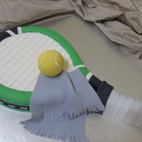 Tennis Racket Cake Made this for a friend's hubby who plays tennis and likes the color green. Carved out of a 9x13 cake. Tennis ball made out of rice...