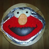 Elmo A 3rd Birthday cake for a co-worker's daughter. The mouth and pupils were made with melted dark chocolate.