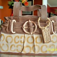 Coach Purse Coach purse cake made for a demonstration party. White cake with lemon buttercream and MMF.P
