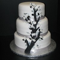 Branch Wedding Cake Branch wedding cake8-10-12 inch tiered cake with black branch, silver & black leaves, white five pedel flowers with silver dragees in...