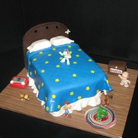 Toy Story 3 Toy Story 3 Cake2 9x13 cakes stacked, covered in fondant, the headboard is made out of modeling chocolateToy box and etch a-sketch are rice...