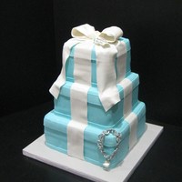Tiffany Cake Tiffany cake, 6-8-10 inch square cakes, fondant bow, bracelet is made out of gum paste, tooth hanging for bracelet is also gum paste, the...
