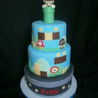 Super Mario Bros Mario is made of gumpaste, 10,8 and 6 inch tiers. White cake with bavarian creme filling. Not much else to say! Thanks for looking!!