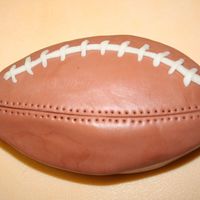 Football My second attempt at a cake. Didn't know what to do with the left overs after making a round cake square. :)