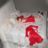 Sugar Night of Romance.Cake is a dark chocolate w/dark chocolate buttercream covered in white fondant. Doll made of fondant.
