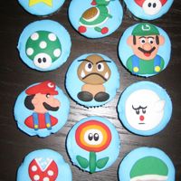 Super Mario Bros Cupcakes Cupcakes made for a Birthday Party. Fondant covered with handmade fondant decoration. I made some fill cupcakes as well that had little...