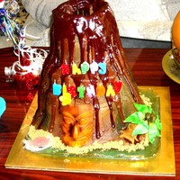 Volcano erupting volcano cake; 5 stacked cakes; top layer hollowed out and ramikan inserted (later filled with jello, lemon juice and baking soda...