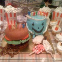 Foodies Cake This was a combination birthday cake for 3 people. Mr. Koolaide, the hamburger and popsicles are all cake. The pretzels were made of rolled...
