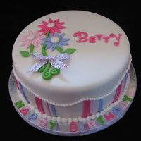 Dainty Daises This is a 10 inch cream cheese almond pound cake covered in mmf. Everything is edible but the bow. The inspiration came from several cakes...