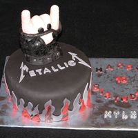 Rock On Metallica This cake was made for a boy who was turning 18 and loves Metallica. The hand was molded from RKT then covered with MMF. Had some...