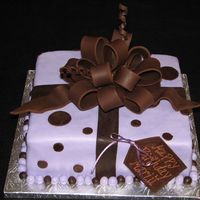 Gift Box The cake is a 10x10 covered in lavender mmf and chocolate fondant ribbon and bow. TFL!