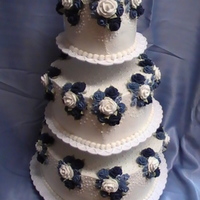 Blue & White Rose Wedding Cake This heart shaped cake is covered in butter cream icing. The flowers are royal icing roses and apple blossoms