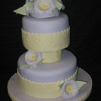 Purple & Yellow Floral Cake This cake is covered in pale purple fondant. I used a textured rolling pin for the design on the yellow fondant that is wrapped around each...