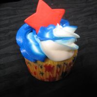 Star Cupcake Blue & white cupcake with a red gumpaste star.