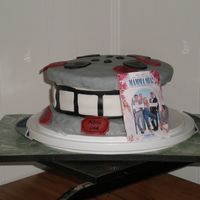 Mamma Mia Movie cake that I did for a get together w/friends. We were watching Mamma Mia hence the mini movie poster. The top & bottom "reel...