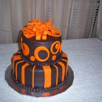 Ashtyn's Cake Chocolate buttercream tinted dark brown with orange fondant circles and stripes.