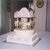 Carousel Cake The horses are all made of cookies with royal icing flowers, hair, & harnesses. Top 'crown' is made of chocolate with royal...