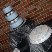 Happy 50Th Birthday This cake was made for a 50th Birthday celebration. The stacked cake is vanilla with buttercream and a fondant overlay. The second cake is...