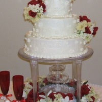 Wedding Cake With Flowers vanilla and chocolate cake with bc icing. Royal icing drop flowers covering the cake. Silk flower arrangements on top and sides. TFL!