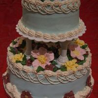 Wilton Third Course Final This is the final cake for the third course, and its my first tiered cake. It is iced with butter cream with royal icing flowers.