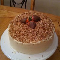 Birthday Cake red velvet with cream cheese icing. topped with chopped Pecans and chocolate covered strawberries