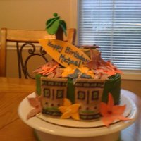 Tiki/hawaiian Cake this was for my friends daughters birthday. chocolate with cream cheese icing, and a the decor is fondant.