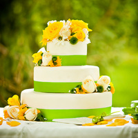 The Natalie Fresh Spring wedding cake, with real white and yellow roses with green ribbon accent.