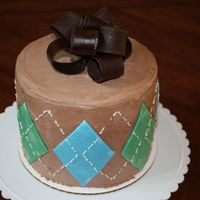 Argyle Cake 4 tier chocolate cake with chocolate Bettercreme. Fondant decoration and royal icing piping. The bow was made with dark chocolate Satin Ice...