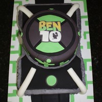 Ben 10 Omnitrix Watch A half sheet cake with an 8" round stacked on top. Fondant accents and fondant decorated board.