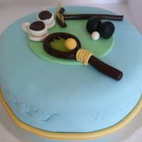 80Th Cake For An Active Woman! A banana cake covered with white chocolate ganache (albeit a little runny) covered with fondant. I made GP tennis racquet & ball, lawn...