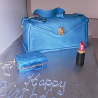 Blue Birthday Purse 4 layer cake with buttercream. Fondant airbrushed blue and then sprayed pearl over. Lipstick is all fondant airburshed as well as the...