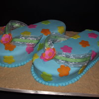 Flip Flops Pumpkin Chocolate Chip cake w/vanilla butter cream covered in fondant.Gum paste flowers and brown sugar and graham cracker crumbs for sand....