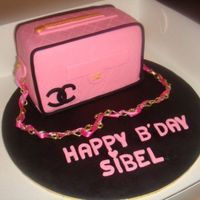 Chanel Bag Cake this was for my friends bday. everything is edible except the chain and the ribbon. its a chocolate mud cake filled with dark chocolate...