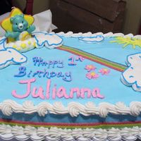 Care Bear I made this using Buttercream Icing the Care Bear is a candle. The child is one year old. The rainbow around the cake and on the cake is...