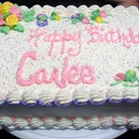 Rose Sprinkles Buttercream icing with the request of sprinkles so I added the flowers and glitzed it up a bit for a young teen's birthday.